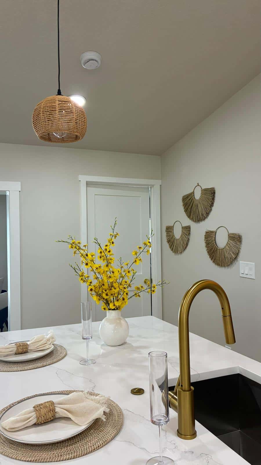 Kitchen with a white marble island and brass faucet after a deep clean in a Tampa Bay home