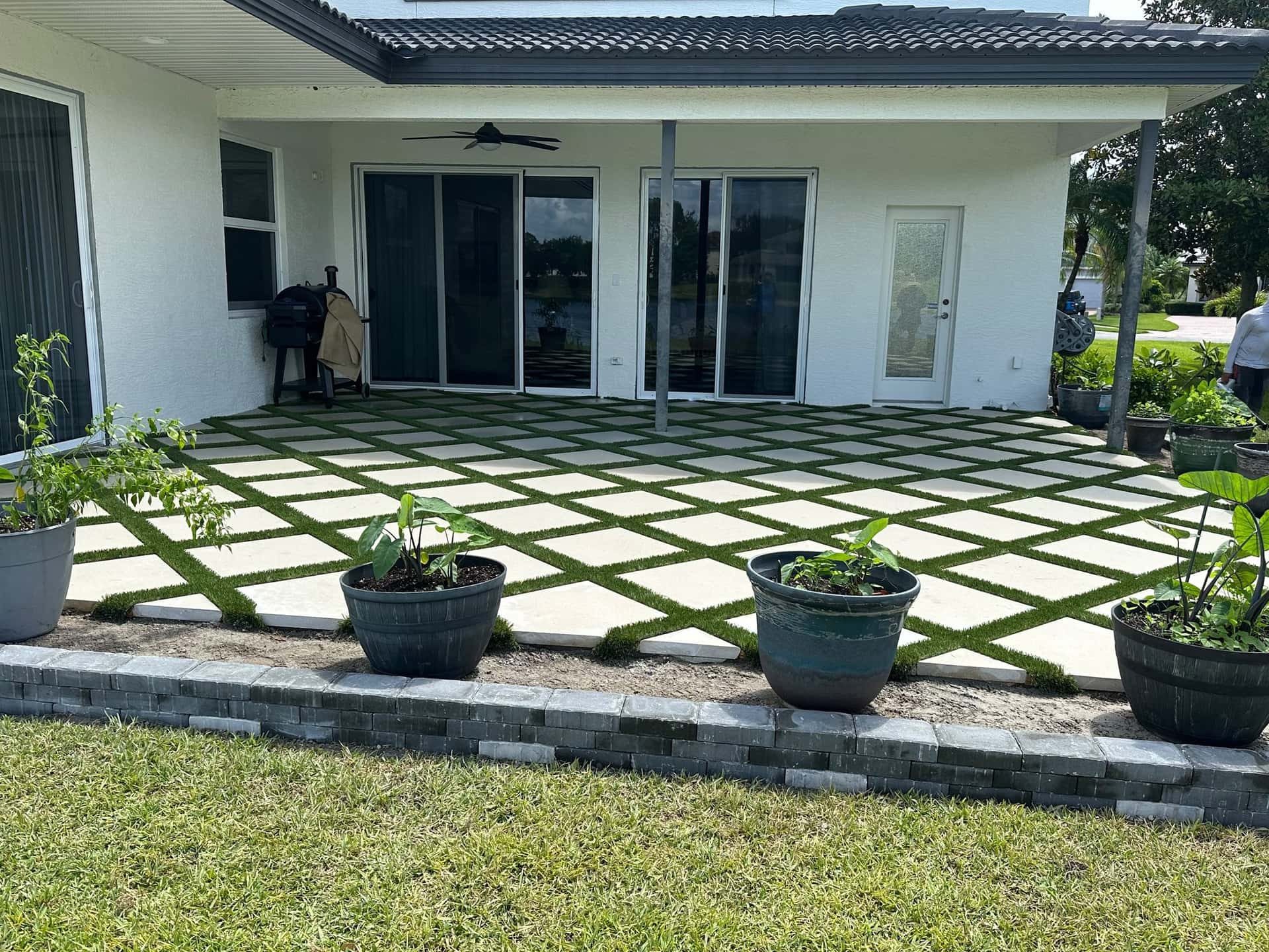 Paver-and-turf backyard patio in Tampa Bay