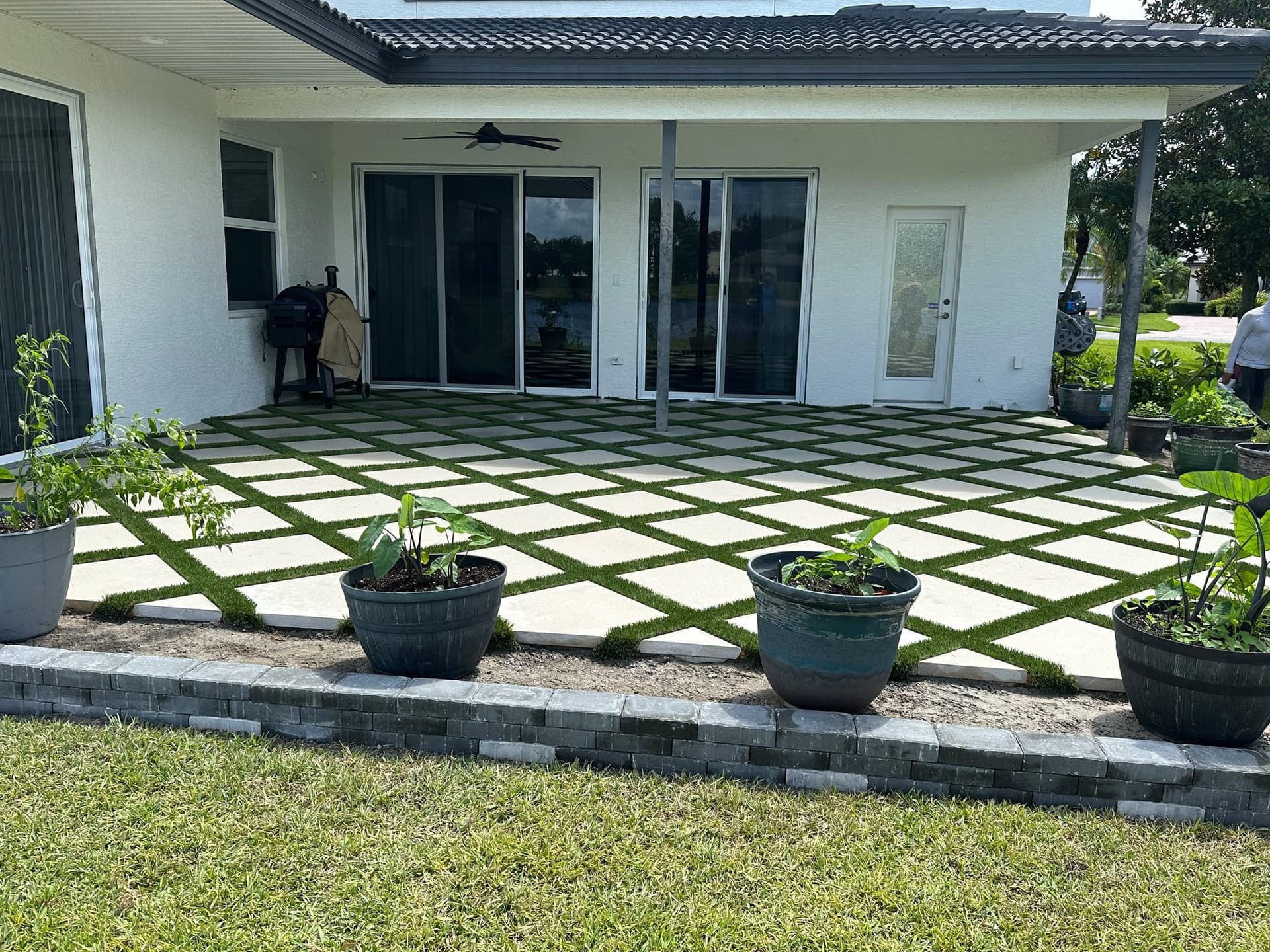Paver-and-turf backyard patio in Tampa Bay