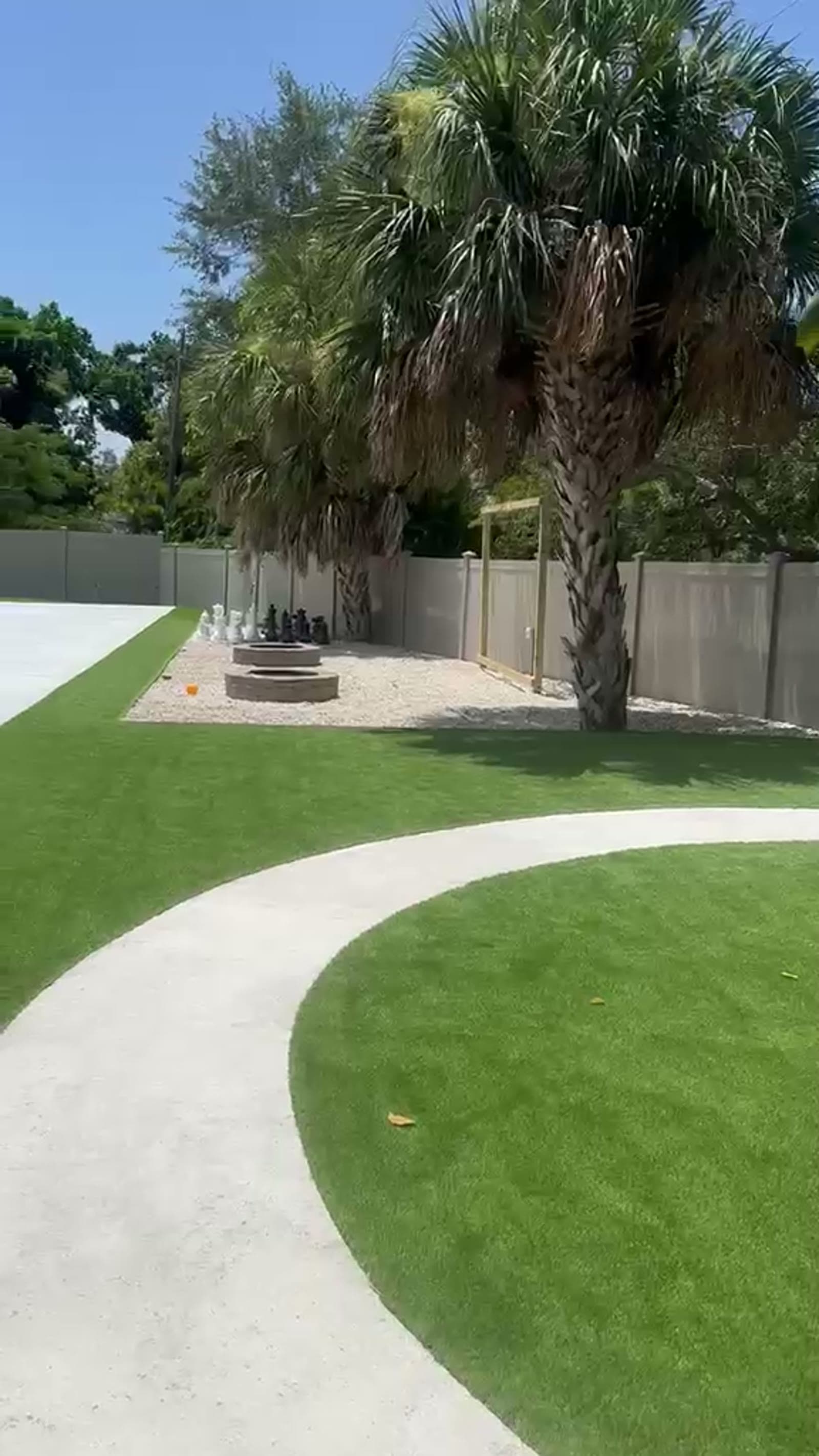 Artificial-turf and paver backyard installed by SRCL Multi Services in Tampa Bay